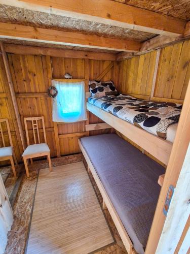 a room with two bunk beds in a cabin at Rusnietis in Rusnė
