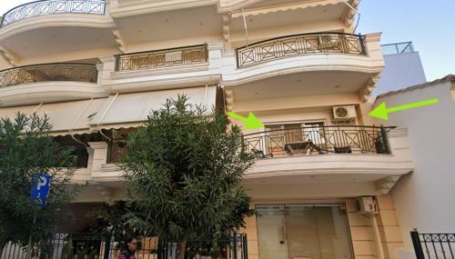 a building with two green arrows on the side of it at Flat studio in Loutraki in Loutraki