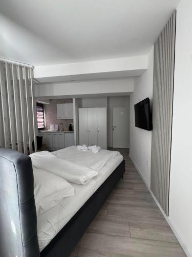 a bedroom with a large bed and a television at Apartmani PROM-AR in Travnik
