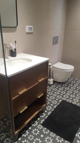a bathroom with a sink and a toilet at Beyond 42 Eilat in Eilat