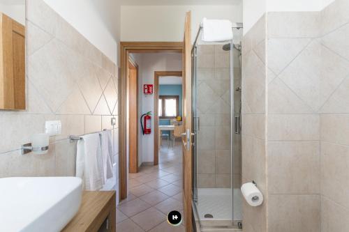 a bathroom with a shower and a sink at Hotels Too - Home Paradiso in Costa Paradiso