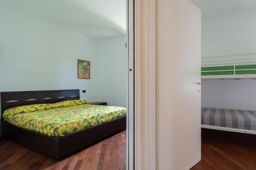 a bedroom with a bed and a sliding glass door at Tavaredo House in Polpenazze del Garda