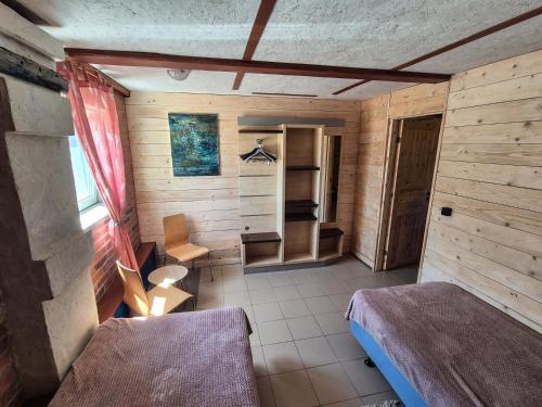 a small room with a bed and a table at Rusnietis in Rusnė
