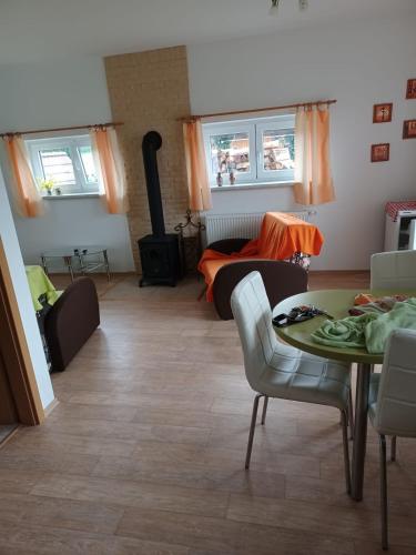 a living room with a table and a couch at Apartmány Kojčice 