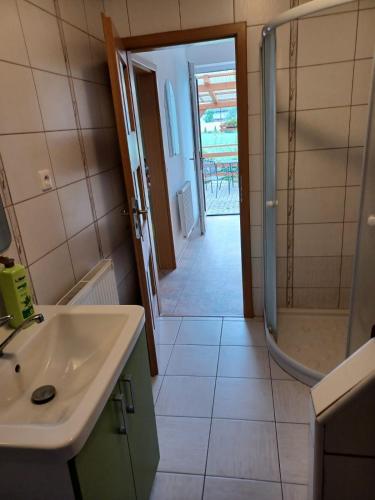 a bathroom with a sink and a shower at Apartmány Kojčice 