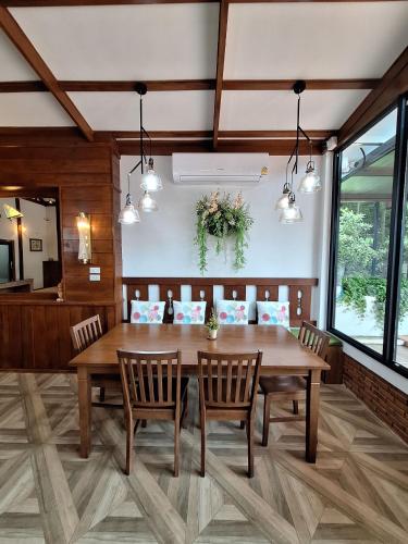 a dining room with a wooden table and chairs at Le-Mao Chiang Dao in Chiang Dao