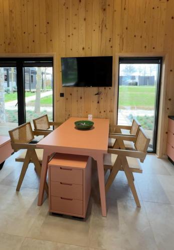 a dining room with a wooden table and chairs at Mileva Koncept in Grivac