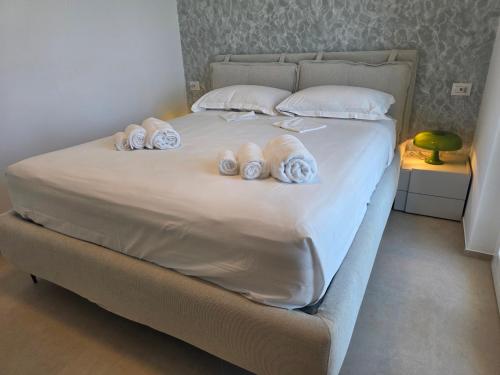 a bed with four pillows on top of it at M4REE Seaside Suites & Relax in Bari