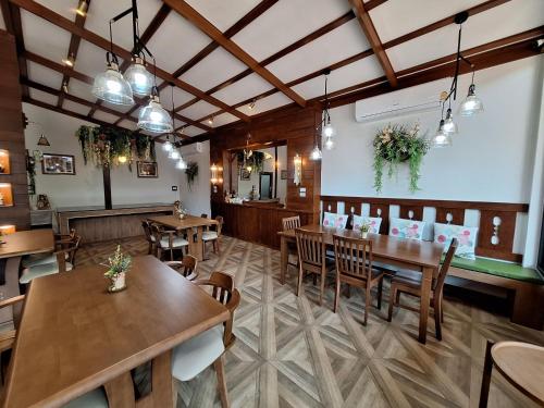 a dining room with wooden tables and chairs at Le-Mao Chiang Dao in Chiang Dao