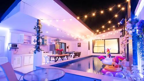 a living room with a swimming pool in a house at Hunter Hide Pool Villa in Jomtien Beach