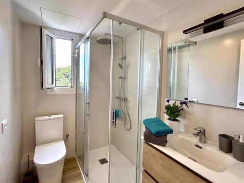 a bathroom with a shower and a toilet and a sink at Cala Morisca full AC Sea View Home in Tossa de Mar