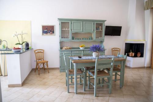 a kitchen with a table and chairs in a room at filìa ϕιλία in Serranova