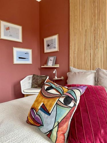 a bedroom with red walls and a bed and a chair at Ballerina Bianca bed & breakfast in Grottazzolina