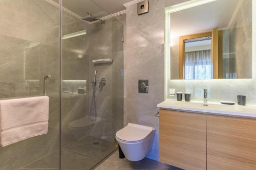 a bathroom with a shower and a toilet and a sink at CityZen - Boutique Studios in Achrafieh in Beirut
