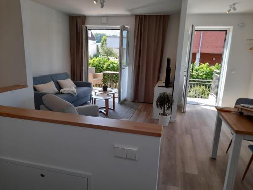 a living room with a blue couch and a table at Seestern 01 in Grömitz
