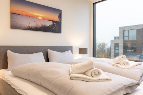 Postel nebo postele na pokoji v ubytování BeltBlick 22 - Stilvolle Ferienwohnung mit Sauna direkt an der Ostsee!