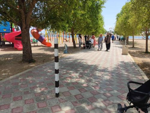 a pole in a park with a playground at Коттедж на озере Иссык Куль in Chok-Tal