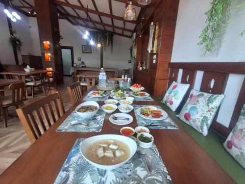 a long table with dishes of food on it at Le-Mao Chiang Dao in Chiang Dao