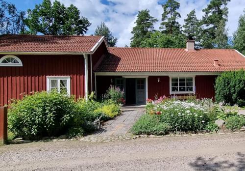 a red house with a red roof at House in Småland near Linneryd, Tingsryd, Korrö in Linneryd