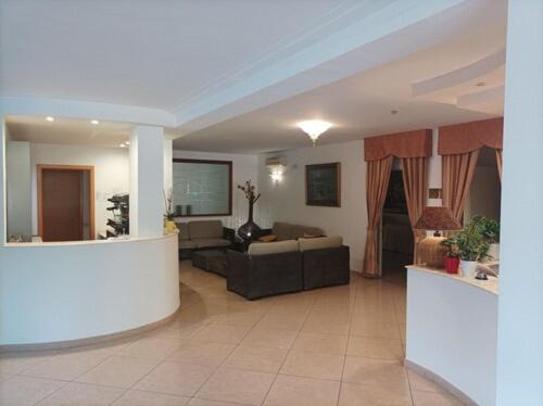a living room with a couch and a table at Magnolia Hotel Vieste in Vieste