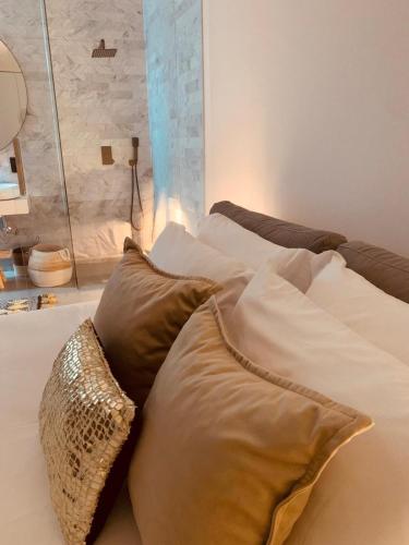 a bed with two pillows on top of it at White Olive Villas in Santarém