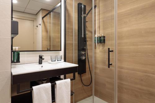 a bathroom with a sink and a shower at Melia Alicante in Alicante
