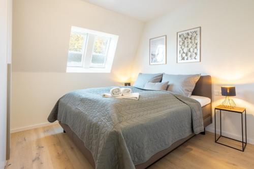 Postel nebo postele na pokoji v ubytování Villa Dornkamp 4 - Luxuriöse Ferienwohnung für 4 Personen inklusive Balkon und Sauna