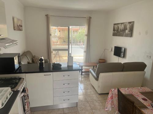 a kitchen and a living room with a couch at Casa Ida 2 Tarrafal, Cape verde in Tarrafal