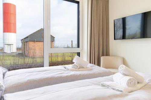 Ένα ή περισσότερα κρεβάτια σε δωμάτιο στο Exklusive Ferienwohnung BeltStrand mit 2 Schlafzimmern und Garten