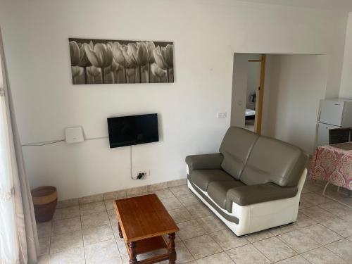 a living room with a chair and a tv at Casa Ida 2 Tarrafal, Cape verde in Tarrafal