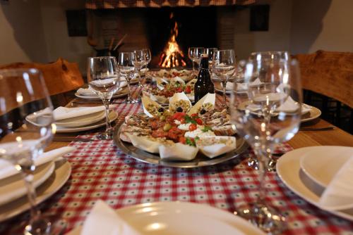 a table with plates and glasses of wine and food at Holiday Home Kerniat in Pula