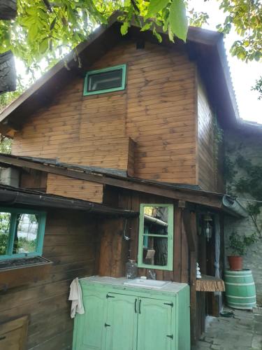 an outside view of a log cabin with a sink at Villa India A-Frame in Ledenik