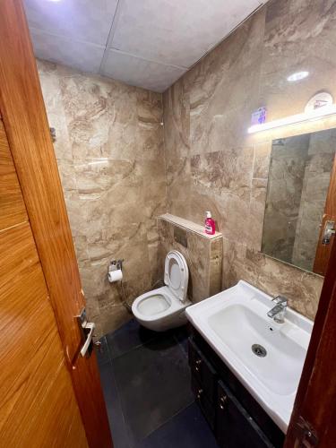 a bathroom with a toilet and a sink at Atha luxury studio 02 in Jāmb