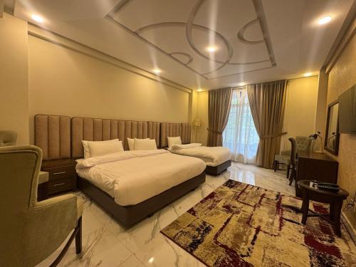 a hotel room with two beds and a couch at Riviera Resort in Naran