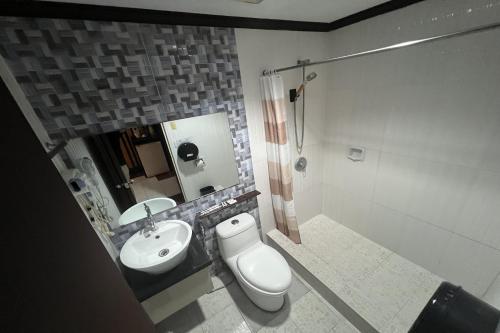 a bathroom with a toilet and a sink at Angeles Palace Hotel in Angeles