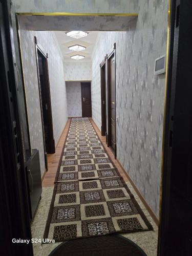 a hallway with a tile floor in a building at Festival Suites Ferghana in Fergana