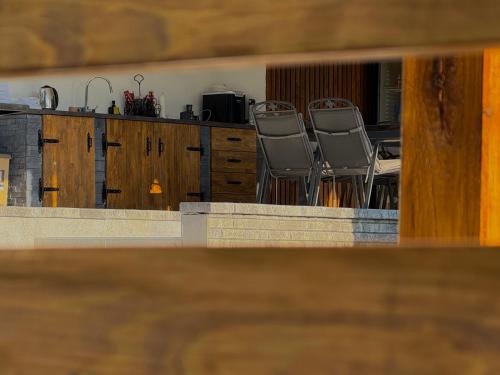 a view of a kitchen with two chairs and a table at Vila Monti 