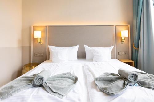 Ένα ή περισσότερα κρεβάτια σε δωμάτιο στο Hotel Germania