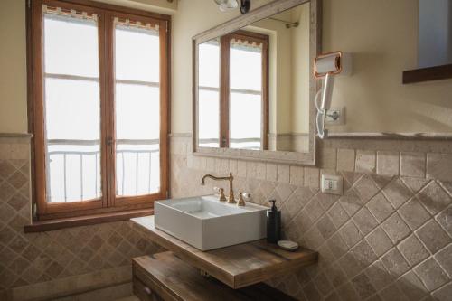 ein Badezimmer mit Waschbecken und Spiegel in der Unterkunft Casale Madonna Grande Wine Resort in Campomarino