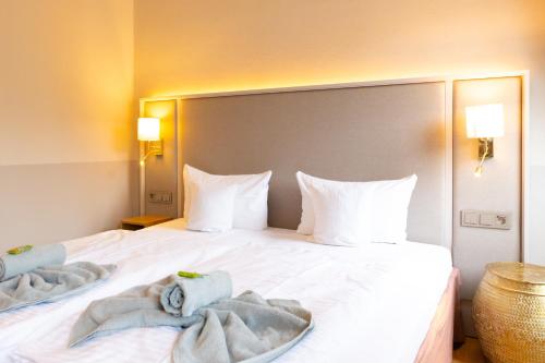 Ένα ή περισσότερα κρεβάτια σε δωμάτιο στο Hotel Germania