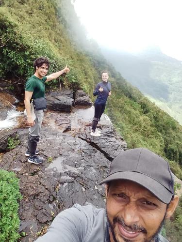 two men walking on a rocky mountain with at Royal Mountain Edge ,Knuckles in Rangala
