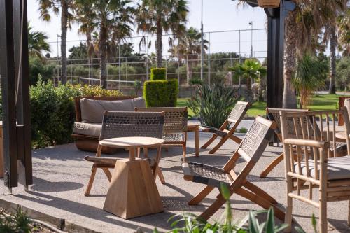 a group of chairs and tables and a couch at Achilleas Beach Hotel Adults Only in Mastichari