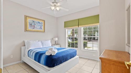 a bedroom with a bed and a ceiling fan at SHVCK3 - Coral Cay Resort #3 - 4 Bed 3 Baths Townhome in Kissimmee