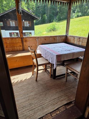 a table and chairs on the porch of a cabin at 400 year old wooden house in Bad Goisern