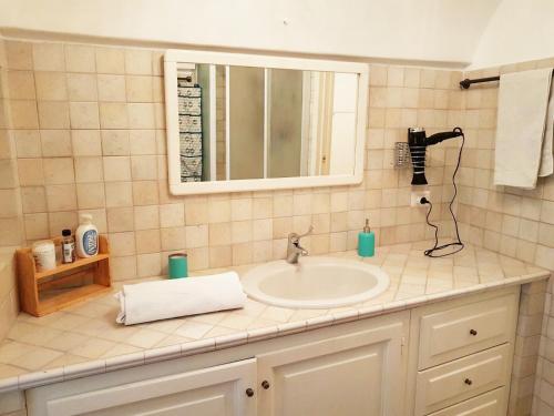 a bathroom counter with a sink and a mirror at Casa Romanzi in Capri