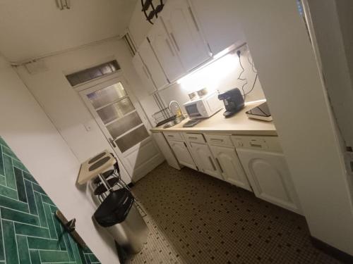a small kitchen with a sink and a window at Rom'antique la Jalouzzie SPA in Dunkerque