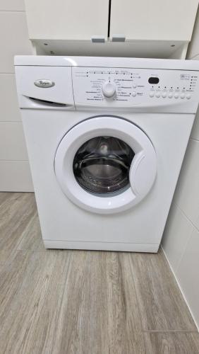 a white washing machine sitting in a room at Voll ausgestattet, Nähe Heiltherme Bad Waltersdorf in Ebersdorf