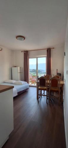 a bedroom with a bed and a table and chairs at House Baglija in Lumbarda