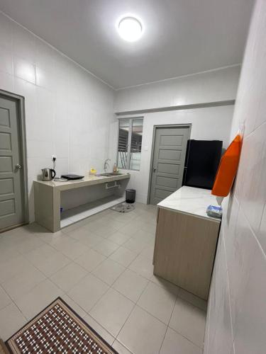a room with a kitchen with a desk and a table at Wake Up Above The City Lights in Sitiawan