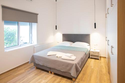 a bedroom with a bed with two towels on it at The New Flat 183 - Ground floor, fully renovated in Athens